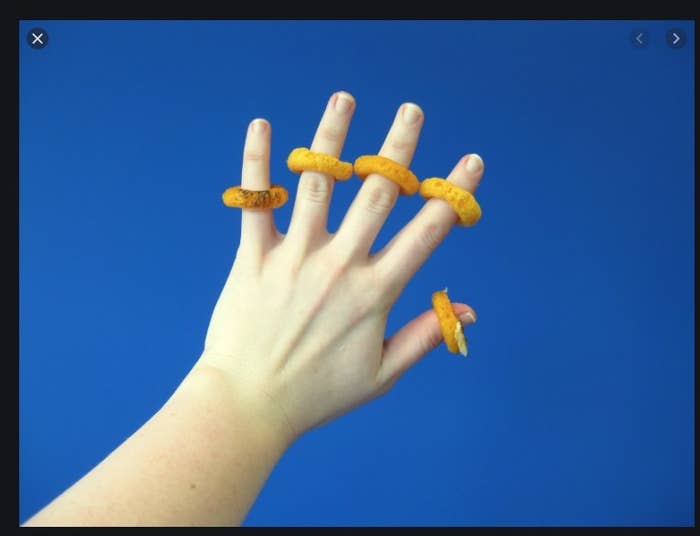 person with burger rings on their fingers