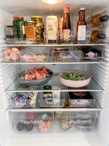 Various labels placed on drawers in a fridge