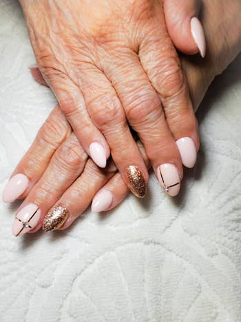 a reviewer's nails with gold accents from the kit