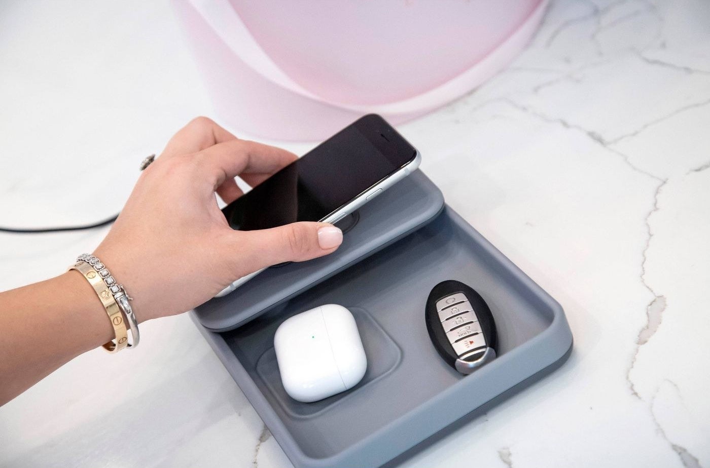 The wireless charger that&#x27;s charging a phone and airpods case