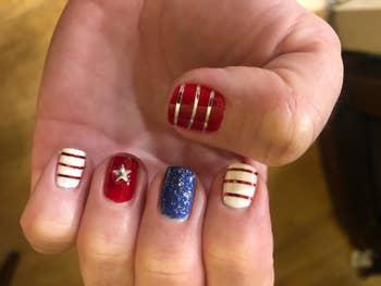 a reviewer's nails done to look like wonder woman