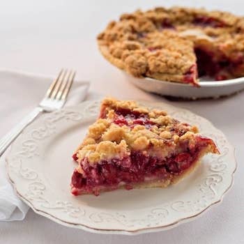 A slice of the cherry crumb pie next to the rest of the pie
