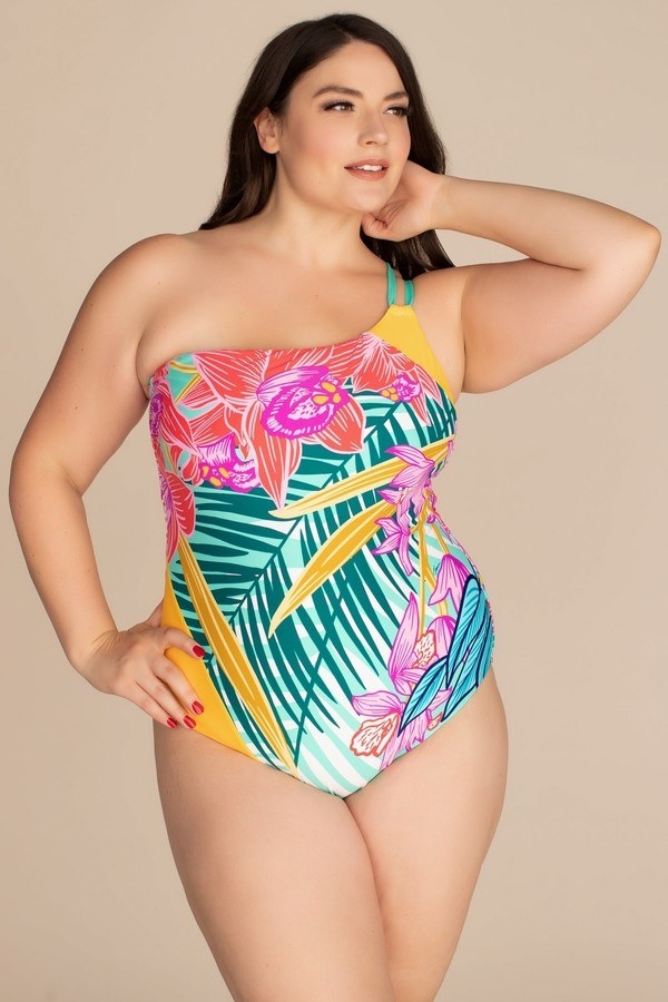 model wearing the one-shoulder tropical print on piece in teals, yellow, blues, and pinks