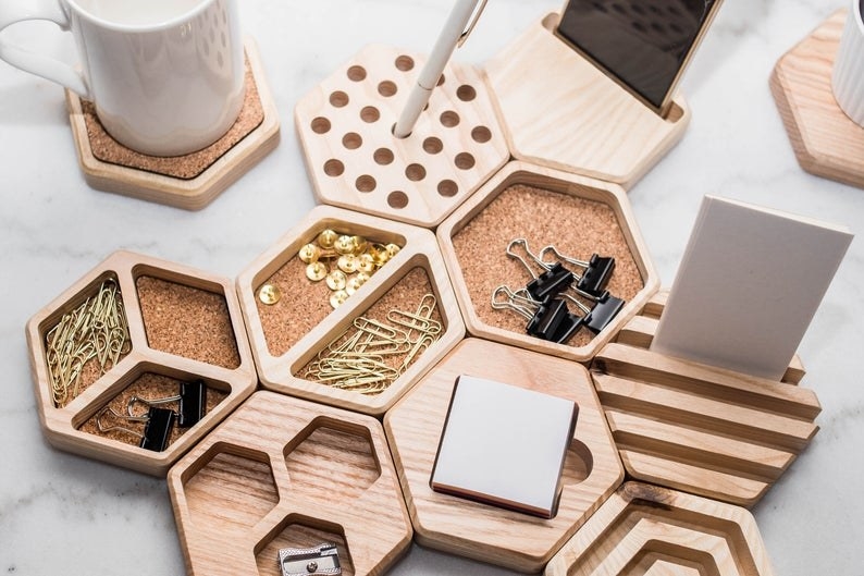 The honeycomb organizers with paperclips, push pins, and other office supplies