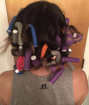 reviewer wearing the curling rods in their hair 