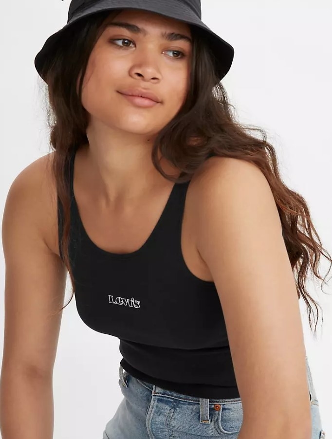 Model wearing black tank with white &quot;Levi&#x27;s&quot; logo