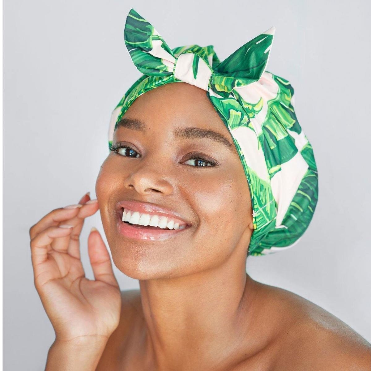 a model wearing the palm leaf shower cap