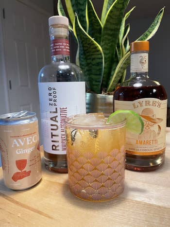 writer's can of ginger avec next to ritual whiskey alternative, lyre's amaretto alternative, and a cocktail garnished with a lime wheel