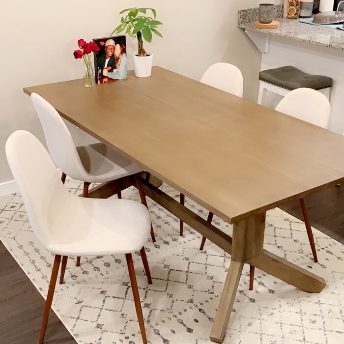 four of the white chairs pulled up to a reviewer's table