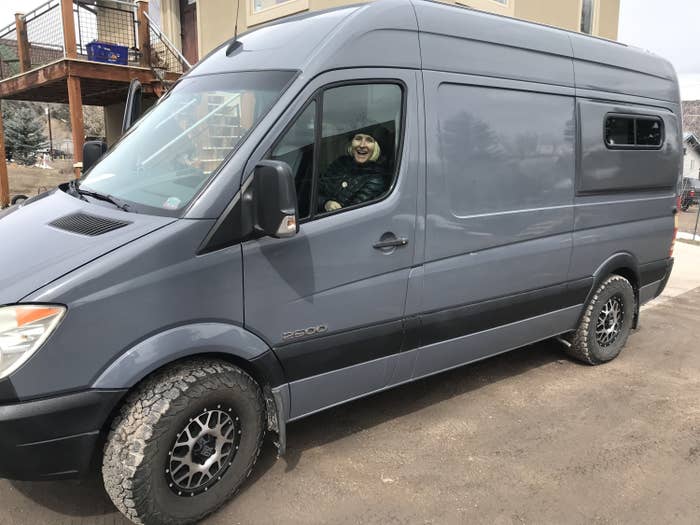 Woman driving a gray van