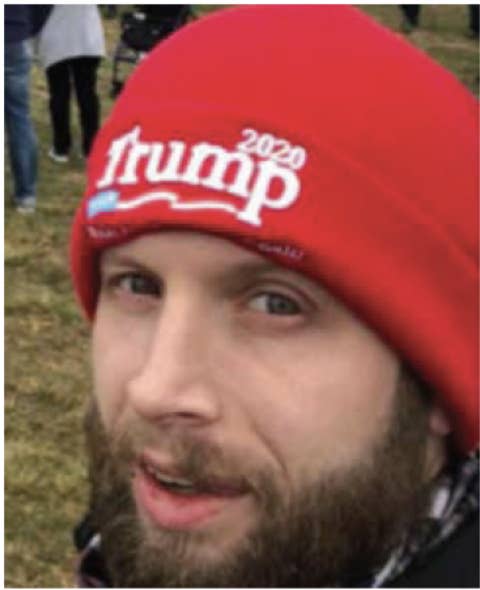 Miller wears a red Trump beanie