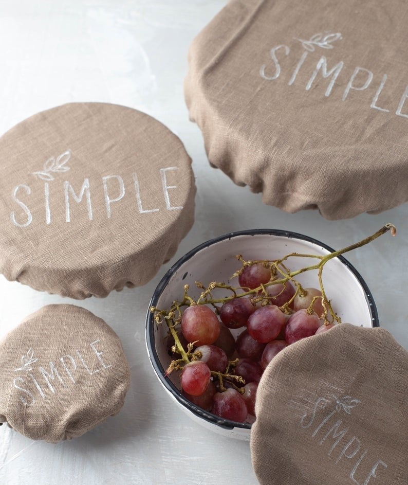 light brown linen elastic cover over a variety of different sizes of bowls