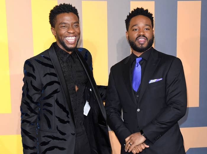 Chadwick gives a big smile while stranding next to Ryan at a premiere 