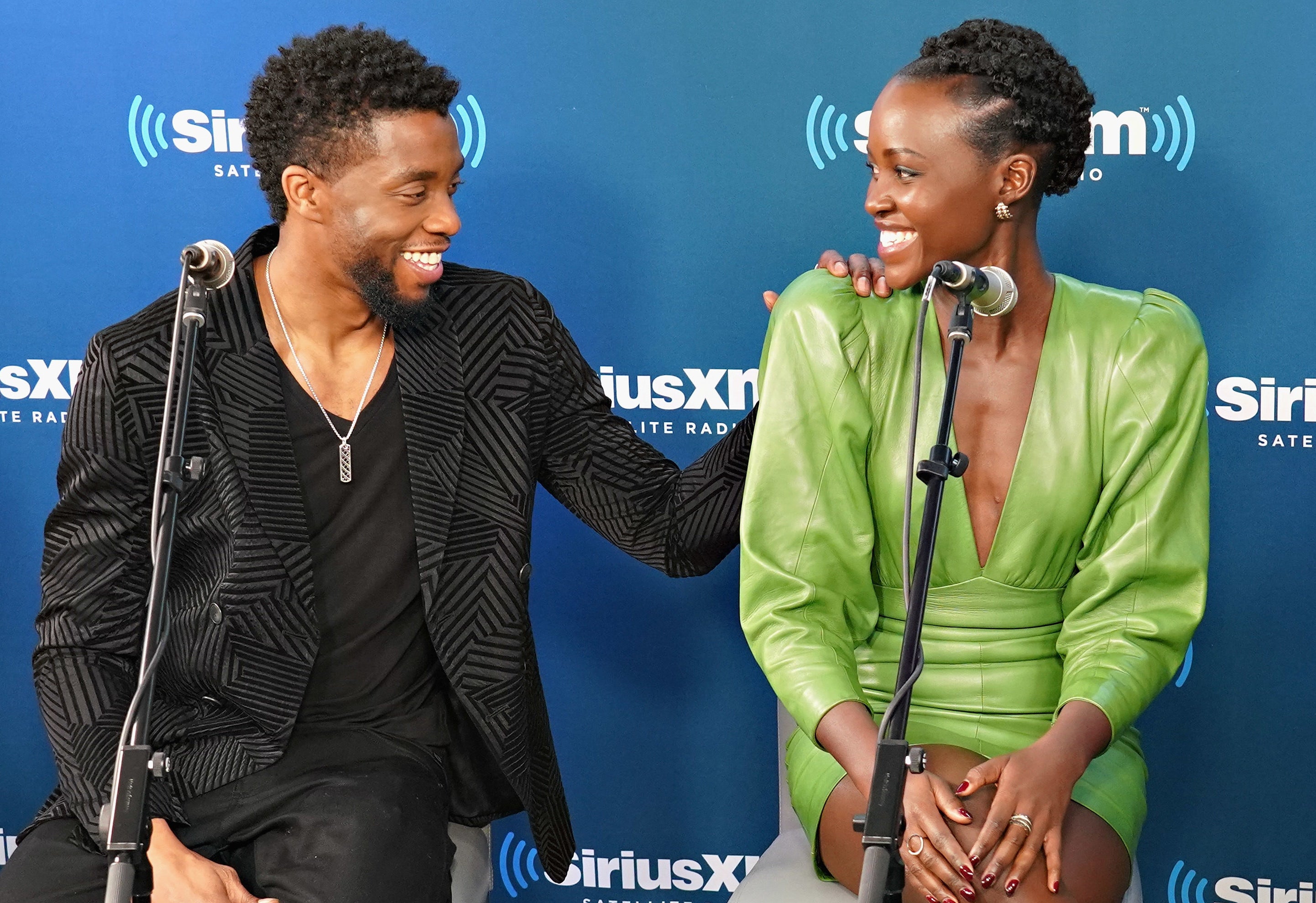 Chadwick puts his hand on Lupita&#x27;s shoulder during an interview