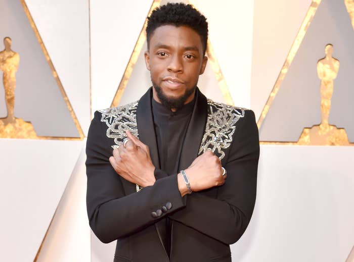 Chadwick does the Wakanda Forever salute at an event