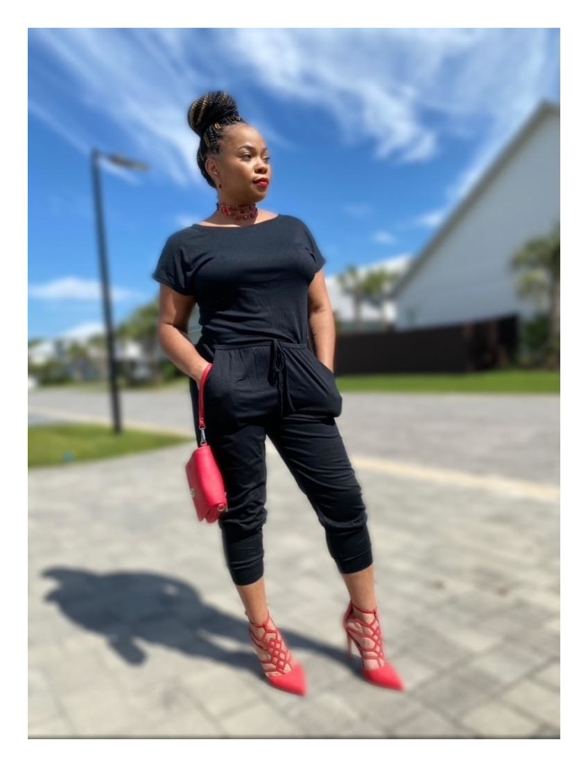 Reviewer wearing black off-the-shoulder jumpsuit