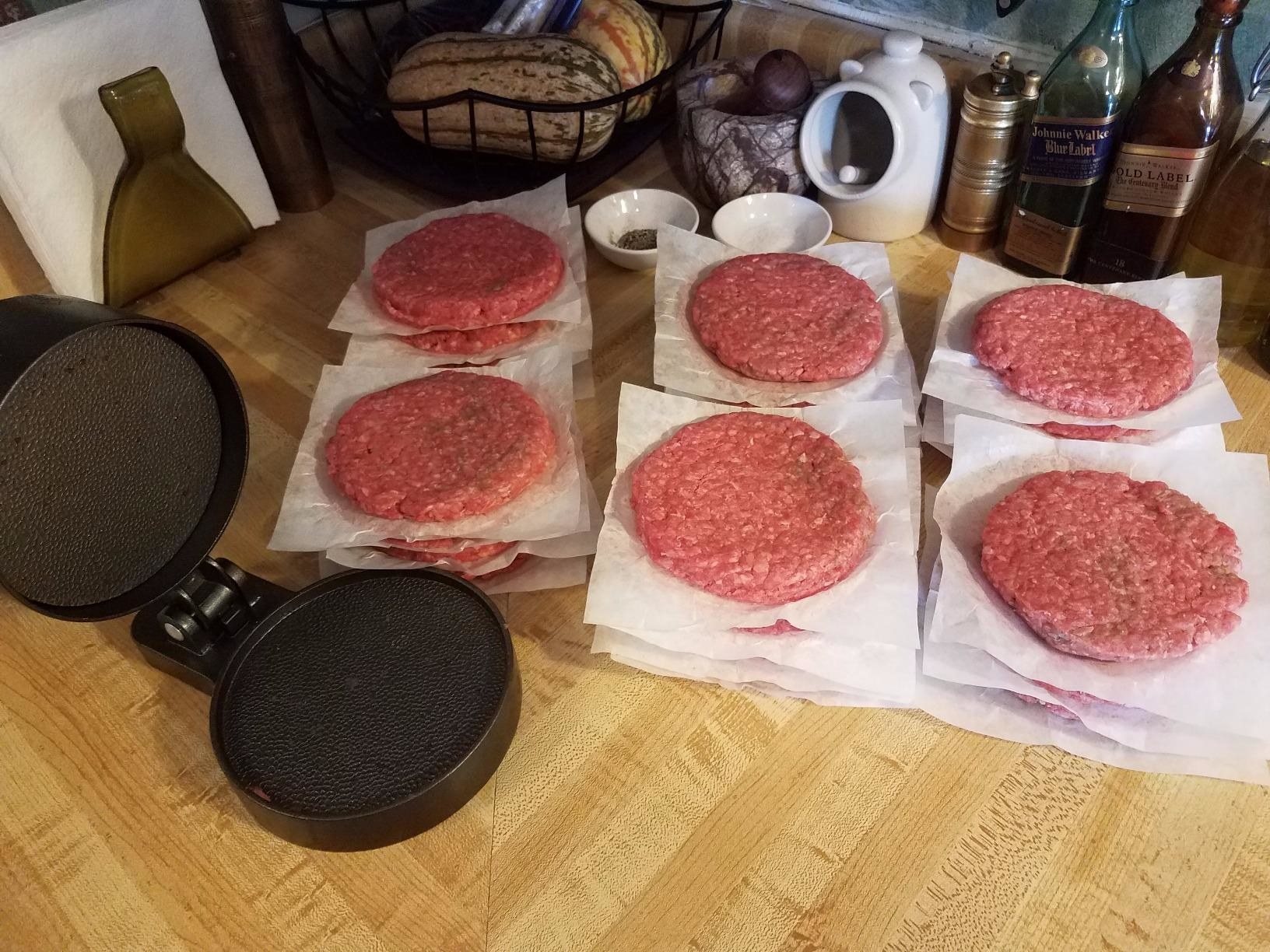 A reviewer shows off dozens of identical patties with their press