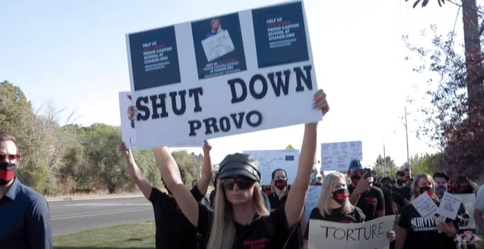 Paris protesting with a sign that says "Shut Down Provo"