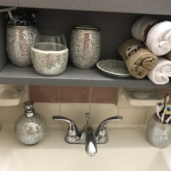 a reviewer's accessory set over their bathroom faucet