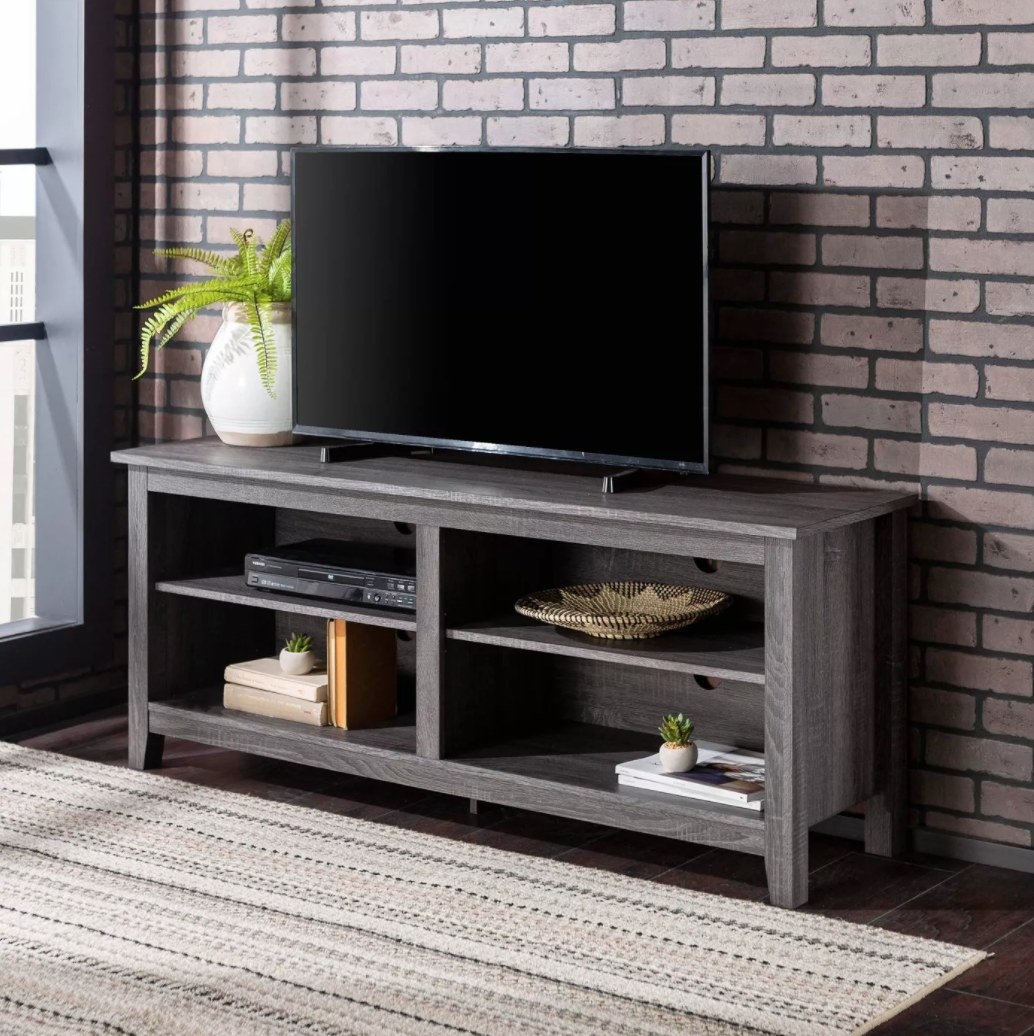 A wooden TV stand with 4 shelves