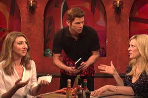 A waiter taking an order from two women