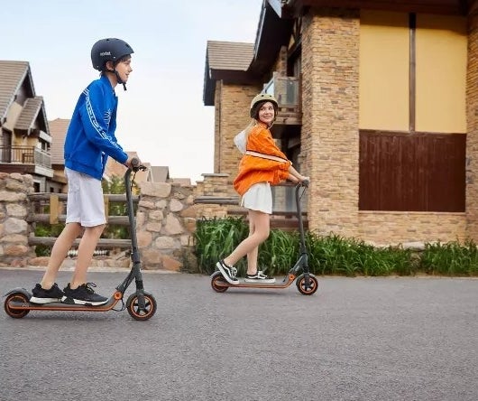 Two kids on electric scooters