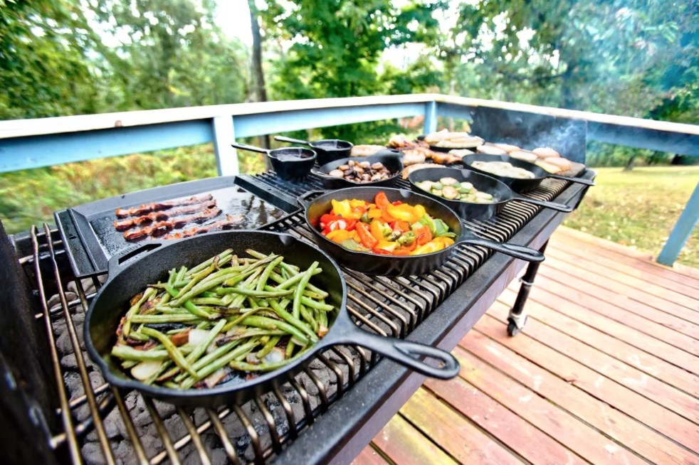 A cast iron 12&quot; skillet on a grill with vegetables