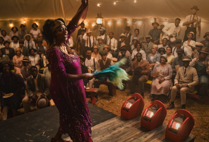 Viola Davis sings on a stage in a tent dressed in 1920s costume