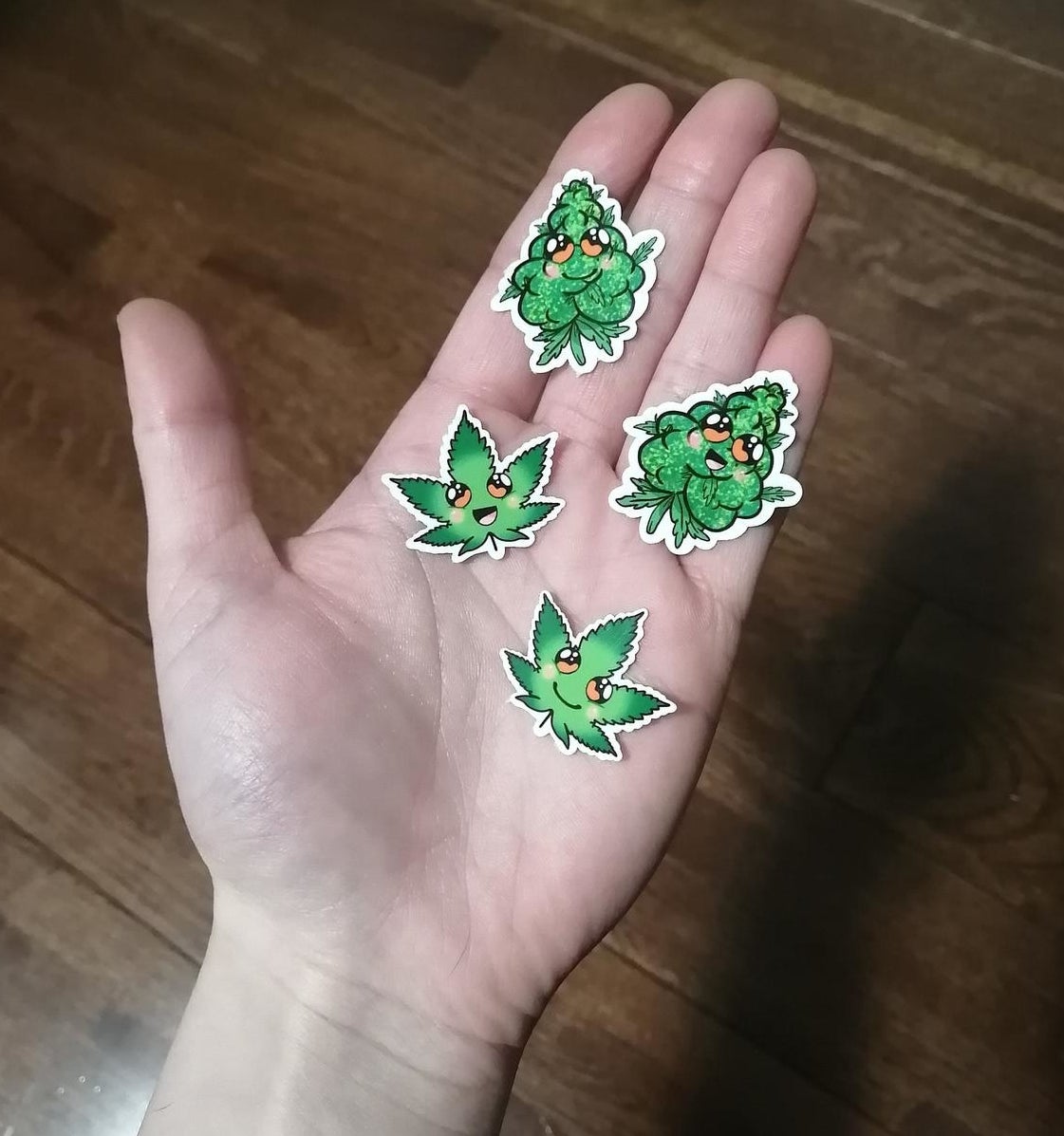 A person holding four stickers