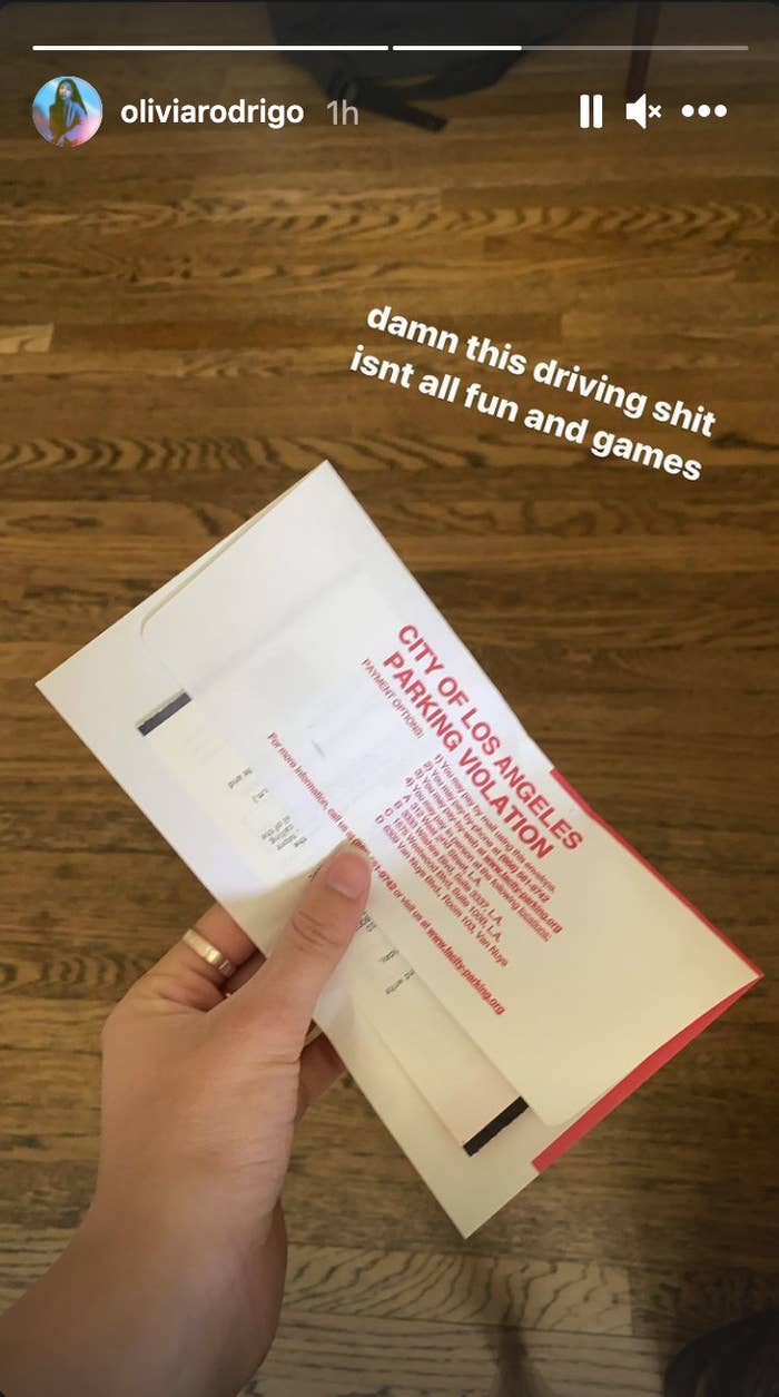 Olivia Rodrigo holding a parking ticket