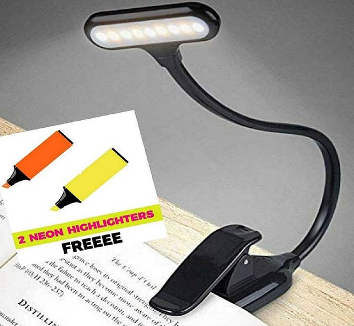 A book light attached to a book, with an inset that says &quot;2 neon highlighters free&quot;.