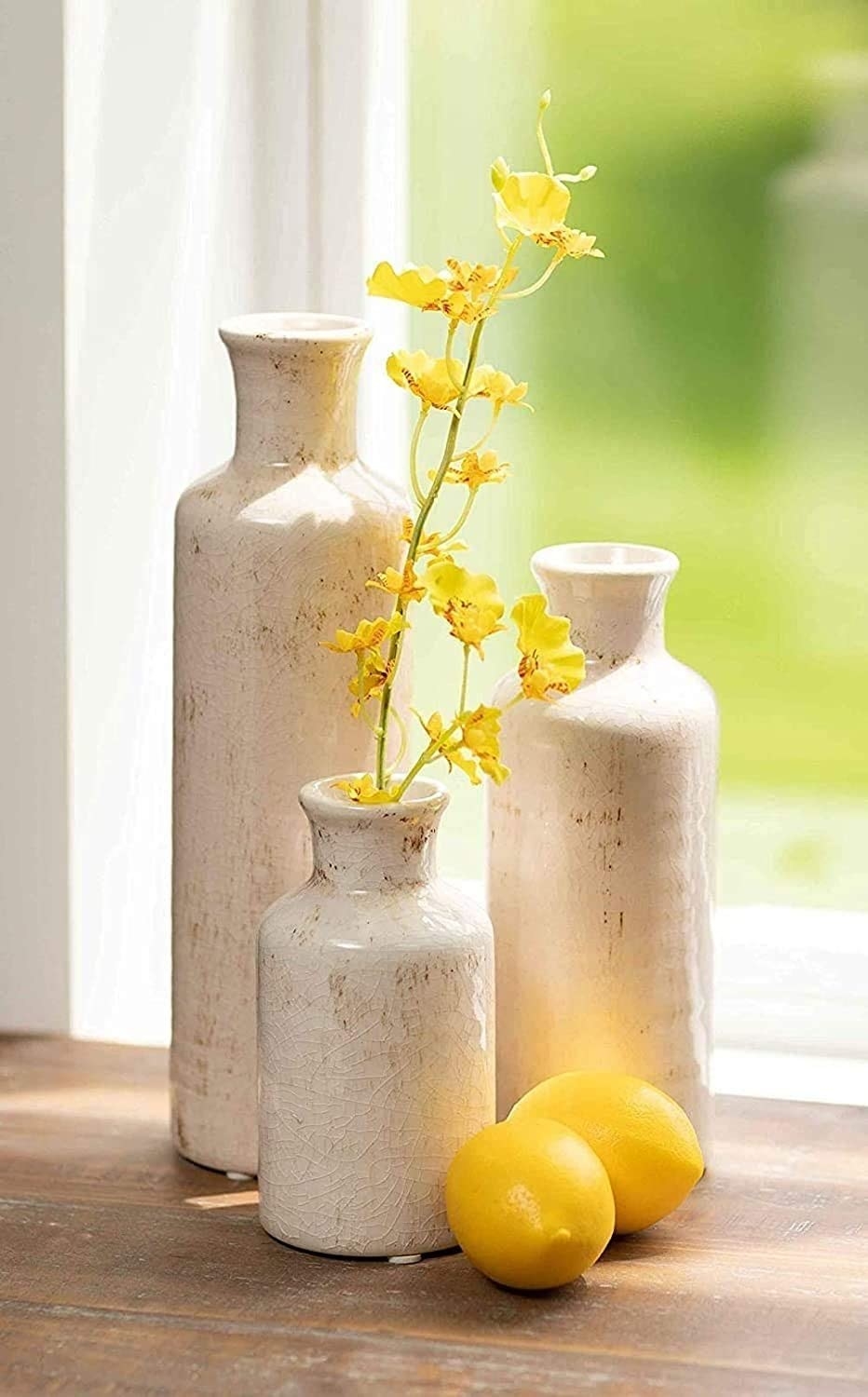 ceramic vases with yellow flowers in it