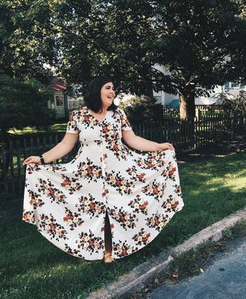 image of plus size reviewer wearing the white floral milumia button up maxi dress on a tree-lined street