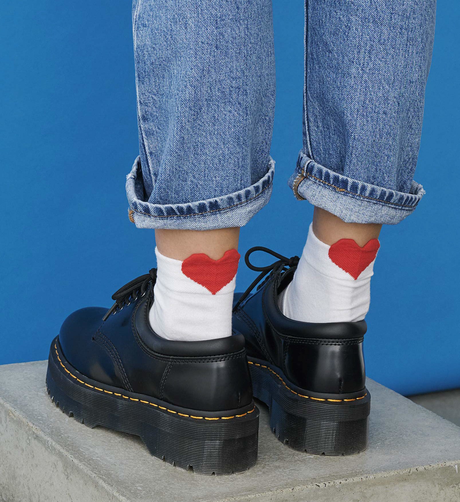 A person wearing socks with big hearts on the backs 