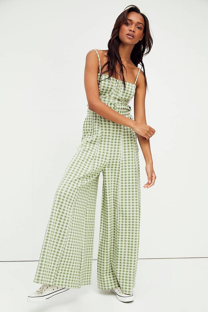 model wearing the floor length green and white checkered jumpsuit