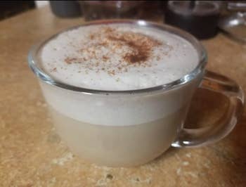 a frothy latte with so much frothy milk on the top