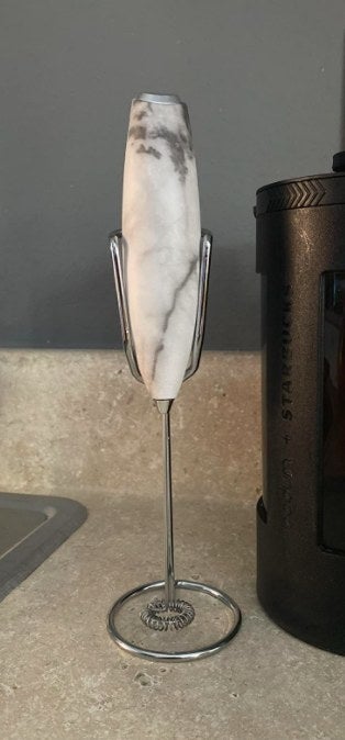 white marble milk frother on a stand