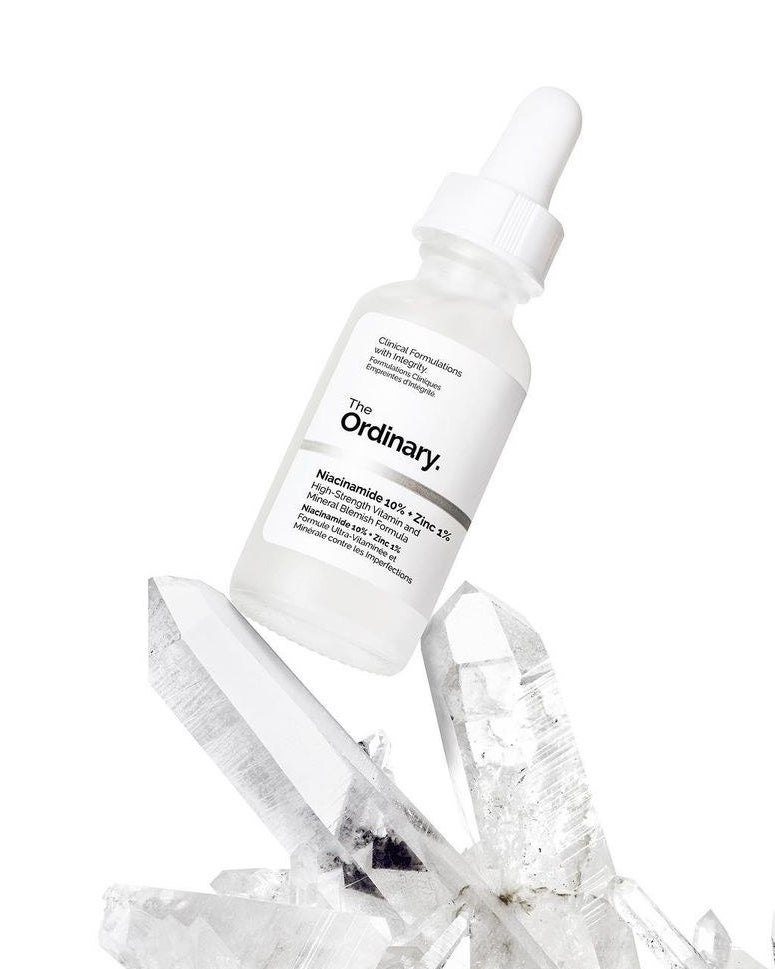 A bottle of the serum on top of some crystals
