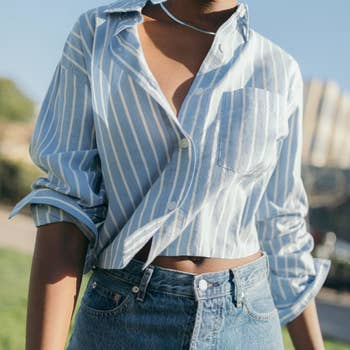 Model wearing the light blue and white vertical-striped shirt