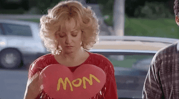 bev from &quot;the goldbergs&quot; cradling a heart that says &quot;mom&quot;
