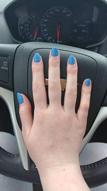 Reviewer showing off nails with a blue color
