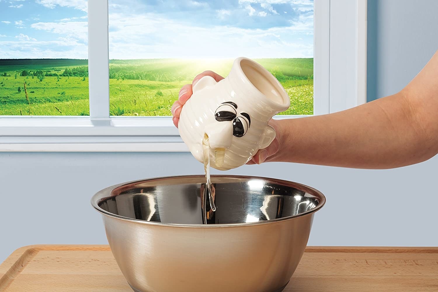 person pouring egg white out of the nose of the separater
