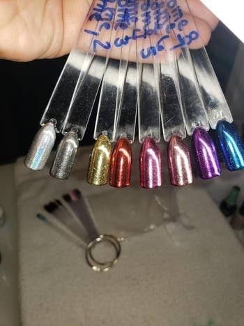 A reviewer photo showing off all eight different colors on fake nails