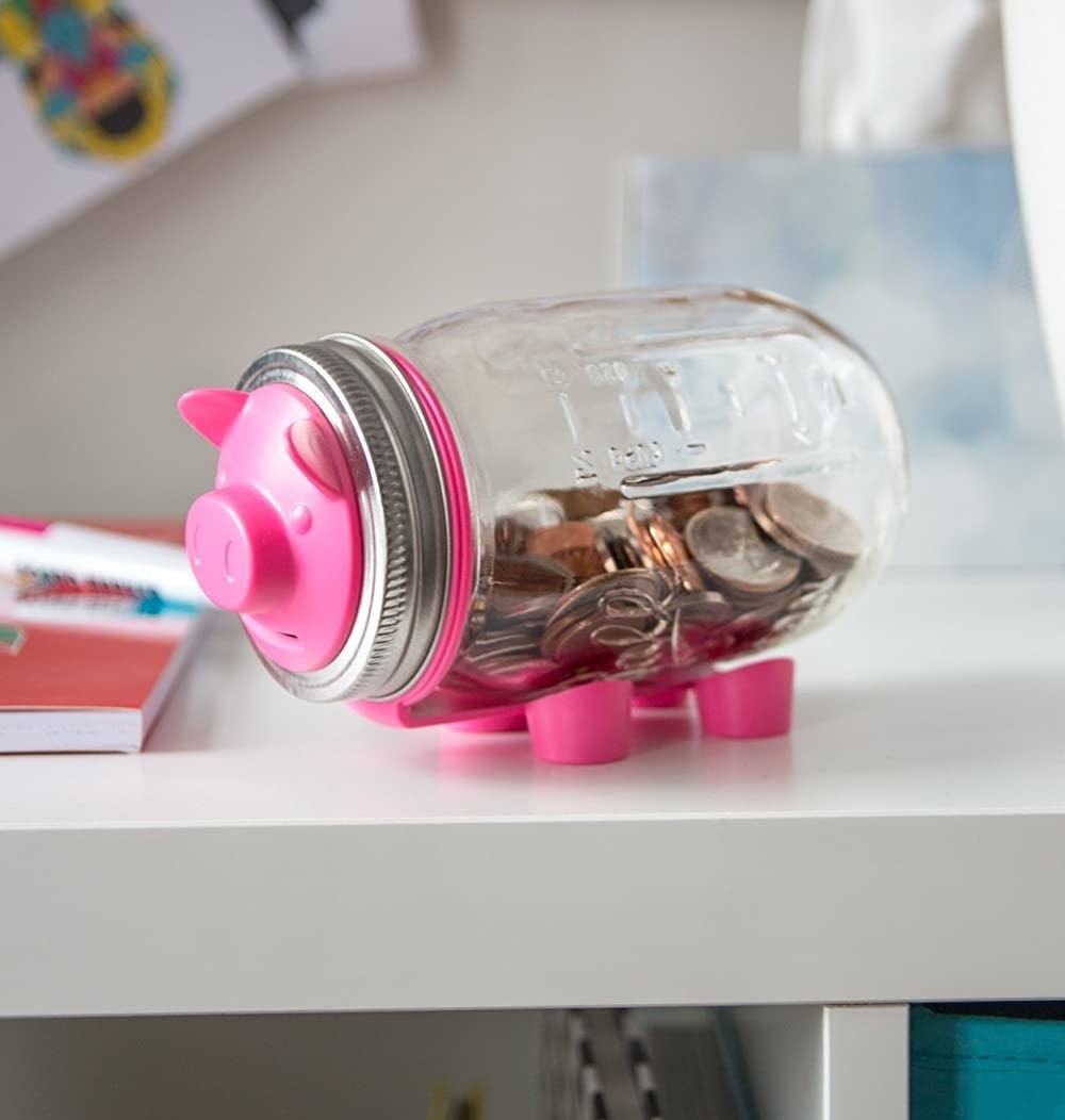 A Mason jar with a pig face on the lid