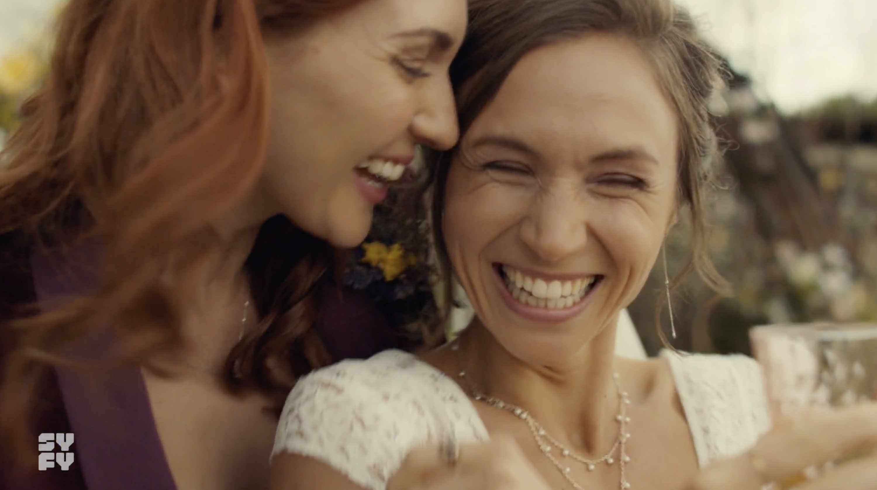 Waverly and Nicole smiling and laughing during their wedding