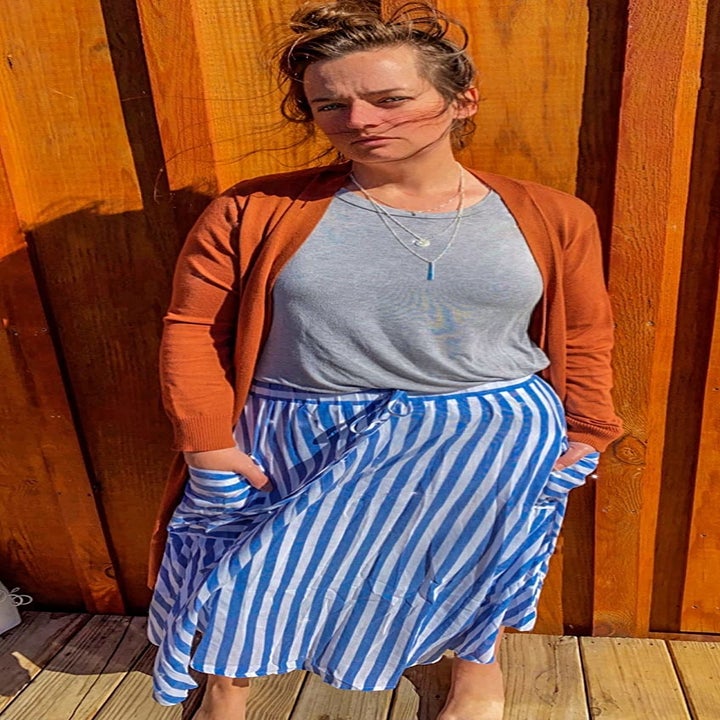 a reviewer wearing the blue and white striped skirt with a T-shirt and cardigan 