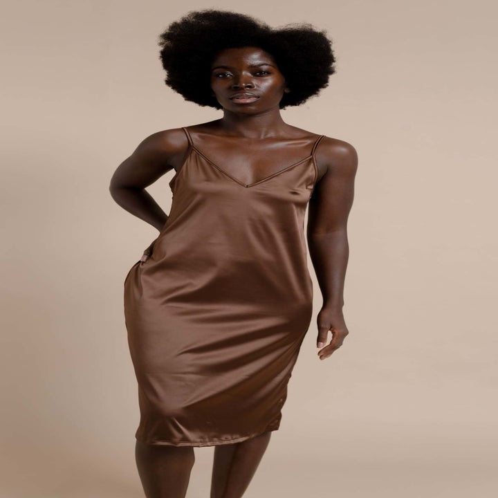 a model wearing a satin slip dress in dark brown 