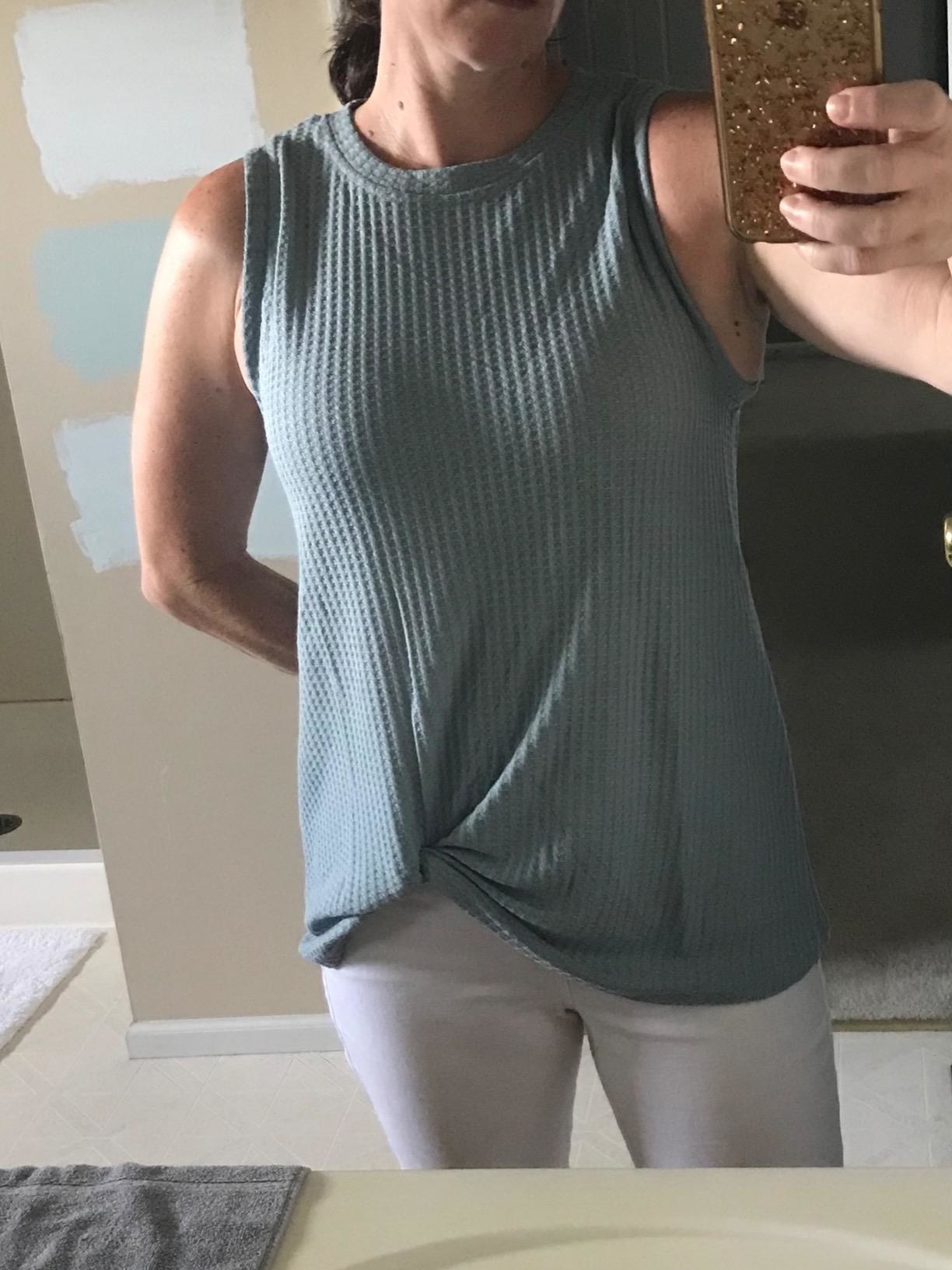 mirror selfie of reviewer wearing the light blue miholl waffle knit tank top