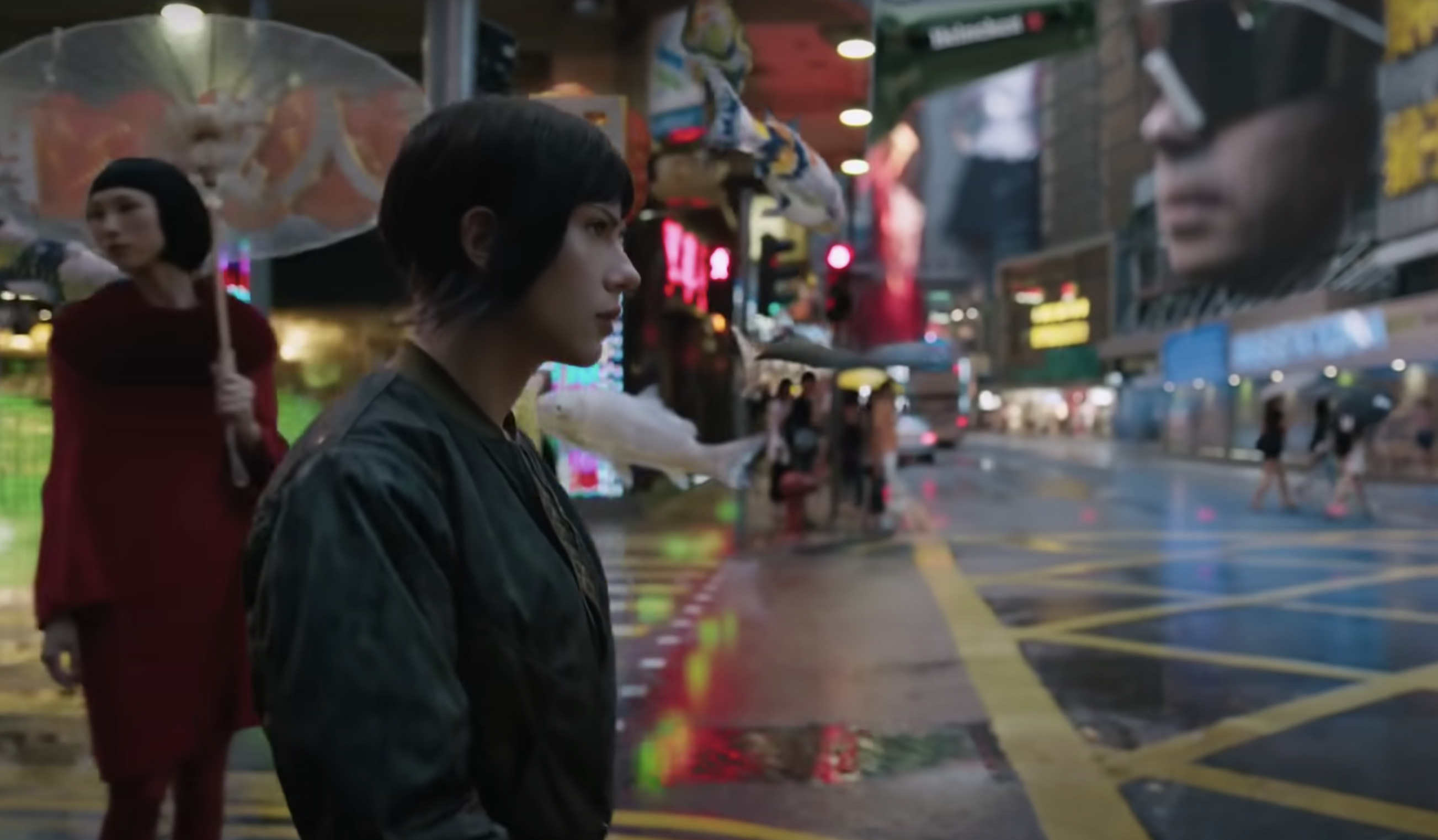 Scarlett Johansson&#x27;s character walks past shops on a street in Japan