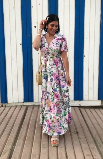 another reviewer wearing short-sleeve button up dress in multi-color pattern